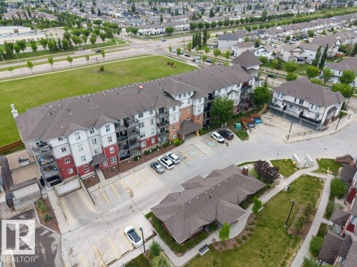 Multi-story residential building featuring a multi-tone facade with red and white siding - 401 667 Watt Boulevard, Edmonton, AB 