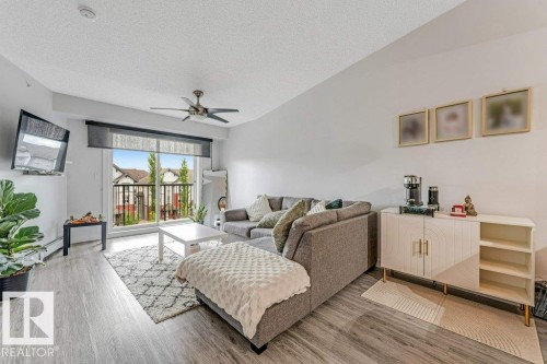 Living space featuring light wood-finish flooring and a ceiling fan - 401 667 Watt Boulevard, Edmonton, AB 