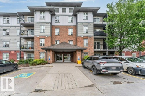 Multi-story building facade featuring brick and siding accents - 401 667 Watt Boulevard, Edmonton, AB 