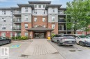 Multi-story building facade featuring brick and siding accents - 401 667 Watt Boulevard, Edmonton, AB 