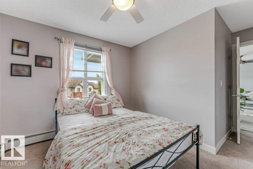 Bright room featuring a window with horizontal blinds, neutral wall paint, and carpet flooring - 401 667 Watt Boulevard, Edmonton, AB 