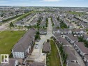 Expansive residential development featuring rows of detached and multi-family homes, mature landscaping, and dedicated green spaces - 401 667 Watt Boulevard, Edmonton, AB 