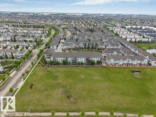 Expansive green space bordered by residential development and a street with mature trees - 401 667 Watt Boulevard, Edmonton, AB 