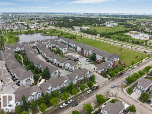 Aerial perspective showcasing a residential development with townhomes and multi-story buildings - 401 667 Watt Boulevard, Edmonton, AB 