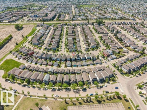 Aerial perspective of a developed residential neighborhood featuring a grid-patterned layout, curvilinear streets, and numerous detached homes - 3511 15A Street, Edmonton, AB 