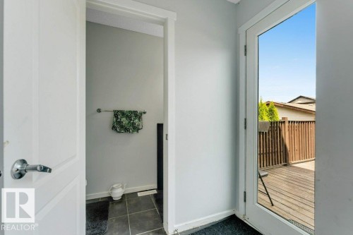 Glass-paneled exterior door opening to a wooden deck - 3511 15A Street, Edmonton, AB 