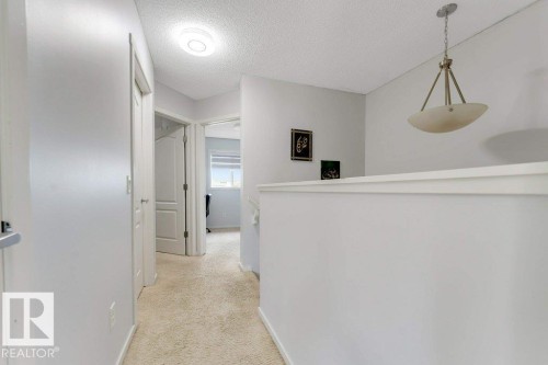 Carpeted hallway with white painted walls and trim - 3511 15A Street, Edmonton, AB 