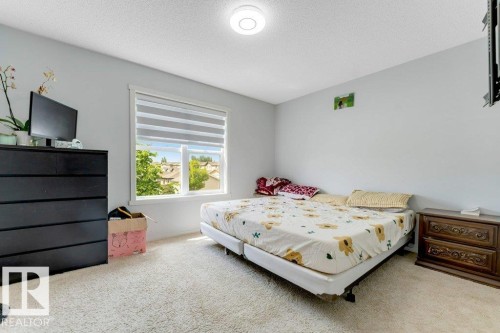 Bright room featuring light gray walls, a window with horizontal blinds, and off-white carpeting - 3511 15A Street, Edmonton, AB 