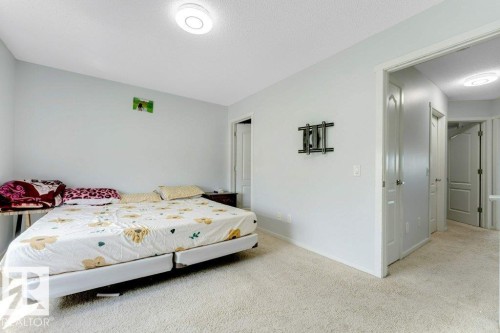 Carpeted room featuring light gray wall paint, a ceiling-mounted light fixture, and white trim - 3511 15A Street, Edmonton, AB 