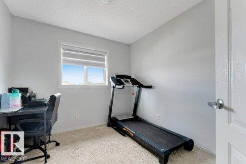 Bright room featuring a window with horizontal blinds, neutral wall paint, and plush carpet flooring - 3511 15A Street, Edmonton, AB 