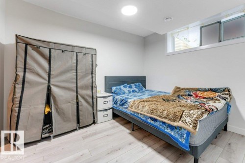 Light wood-finish flooring with crisp white walls, a recessed ceiling light, and a horizontal window - 3511 15A Street, Edmonton, AB 