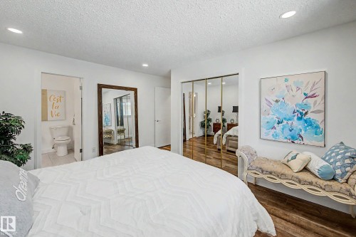 Bright bedroom with wood-finish flooring and recessed lighting - 3718 103B Street Nw, Edmonton, AB - Indoor Photo Showing Bedroom