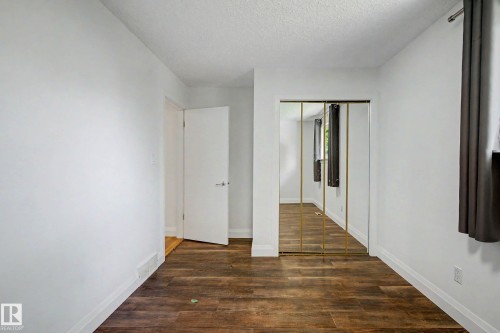 Room featuring wood-finish flooring, white baseboards, and white walls - 3718 103B Street Nw, Edmonton, AB - Indoor Photo Showing Other Room