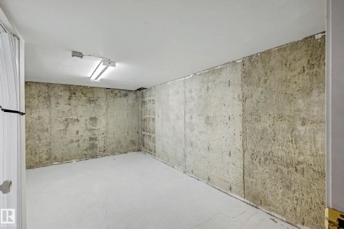 Unfinished interior space featuring a concrete floor with a light gray paint finish and exposed concrete walls - 3718 103B Street Nw, Edmonton, AB - Indoor