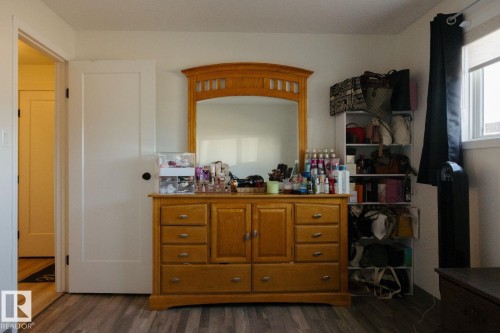 Hard-surface flooring with a wood-look finish - 10503A 109 Street, Westlock, AB - Indoor Photo Showing Bedroom