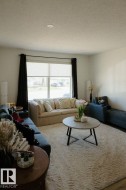 Bright living area featuring a large window, recessed lighting, and ample natural light - 