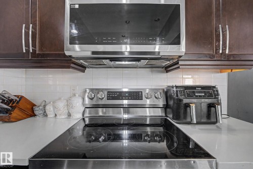 Stainless steel over-range microwave and electric range with a smooth cooktop - 1944 68 Street, Edmonton, AB 