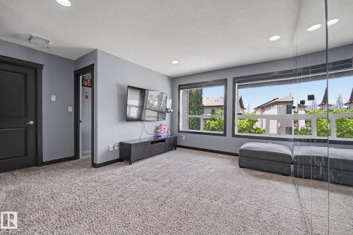 Carpeted interior space featuring light gray walls and recessed lighting - 1944 68 Street, Edmonton, AB 