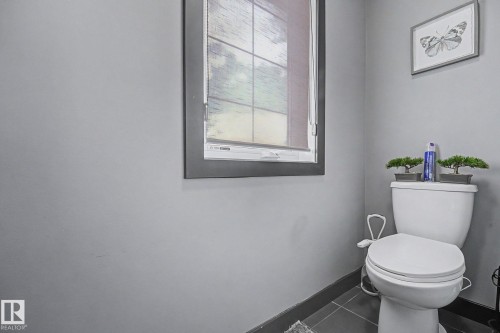 Gray-painted walls featuring a framed window with a roller shade - 1944 68 Street, Edmonton, AB 