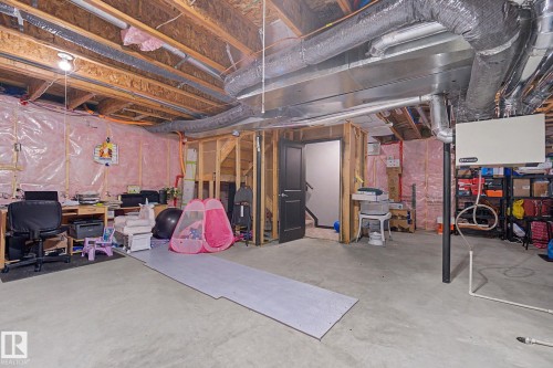 Unfinished basement with exposed wood joists and concrete flooring - 1944 68 Street, Edmonton, AB 