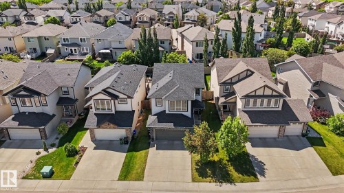 Contemporary detached home featuring a two-car garage, partial stone facade, and a covered front entry - 1944 68 Street, Edmonton, AB 
