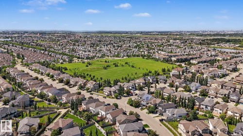 Aerial perspective of a developed residential area featuring numerous single-family homes with pitched roofs - 1944 68 Street, Edmonton, AB 