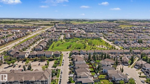 Expansive aerial view showcasing a developed residential neighborhood with a central green space - 1944 68 Street, Edmonton, AB 