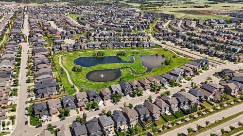 Aerial view showcasing a residential development with extensive green spaces and water features - 1944 68 Street, Edmonton, AB 
