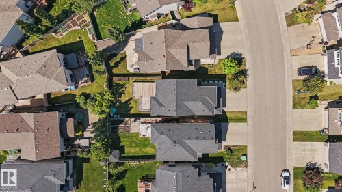Aerial view highlighting multiple residential properties with pitched roofs, individual driveways, and private fenced backyards - 1944 68 Street, Edmonton, AB 