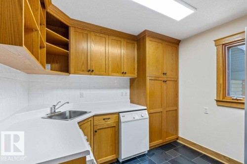 Pantry/ laundry room featuring Miele washer and dryer plus Subzero freezer, custom oak cabinets. - 738 Wheeler Road, Edmonton, AB 
