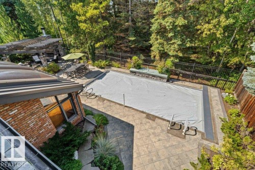 View of swimming pool with a patio area, a fenced backyard, and a covered pool - 738 Wheeler Road, Edmonton, AB 