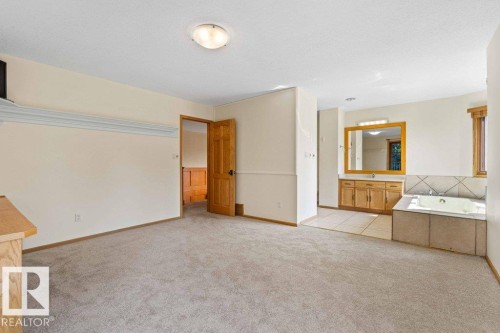 bedroom with new carpet flooring and ensuite with jet tub and shower - 738 Wheeler Road, Edmonton, AB 