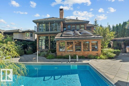 Back of property with two balconies, complete stone patio and pool. - 738 Wheeler Road, Edmonton, AB 