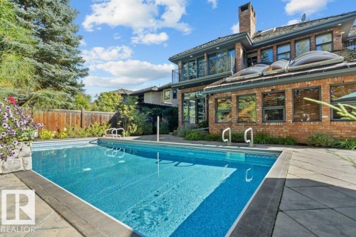 Back of property with two balconies, complete stone patio and pool. - 738 Wheeler Road, Edmonton, AB 