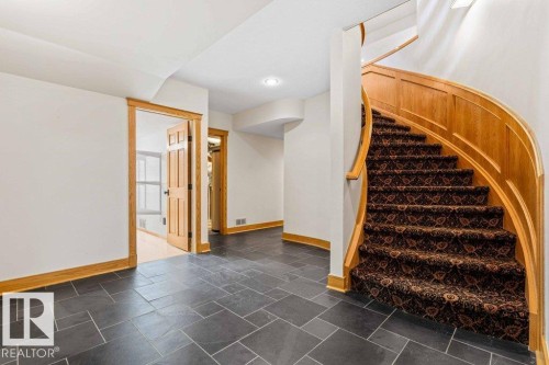 Stairway to lower level with luxury wool carpet and slate tile floor. - 738 Wheeler Road, Edmonton, AB 