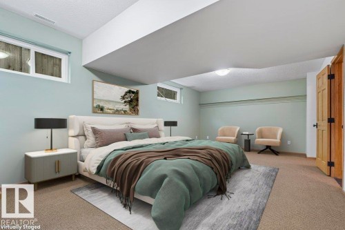 Carpeted bedroom featuring a textured ceiling - 738 Wheeler Road, Edmonton, AB 
