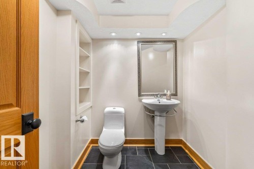 Half bath with dark tile patterned floors, a textured ceiling, and recessed lighting - 738 Wheeler Road, Edmonton, AB 