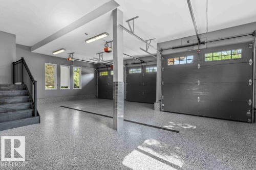 Garage featuring epoxy floor with drain, heated floors, custom millwork and Snap On tool chest. - 738 Wheeler Road, Edmonton, AB 
