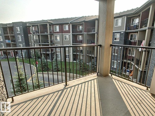 Concrete balcony with black metal railings - 328 3315 James Mowatt Trail, Edmonton, AB 