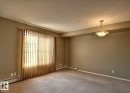 Spacious room featuring neutral carpeting and painted walls - 328 3315 James Mowatt Trail, Edmonton, AB 