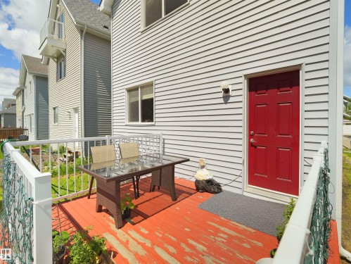 Exterior deck with red-painted wood flooring and white railing - 7827 22 Avenue, Edmonton, AB 