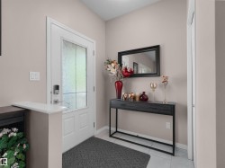 Entryway featuring a white door with frosted glass, smart lock hardware, and light-toned wall finishes - 