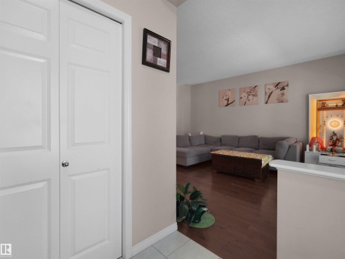 Entryway featuring bi-fold doors and tile flooring - 7827 22 Avenue, Edmonton, AB 
