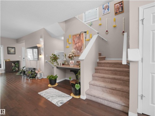 Warm wood-finish flooring extending into living areas - 7827 22 Avenue, Edmonton, AB 