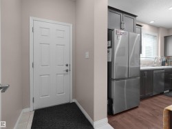 Panel-style interior door framed by neutral walls and white trim - 