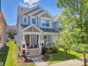 Two-story residence featuring light blue siding with contrasting brown-shingled gables - 7827 22 Avenue, Edmonton, AB 