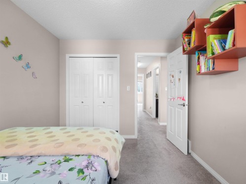 Bedroom with light neutral wall paint and textured ceiling - 7827 22 Avenue, Edmonton, AB 