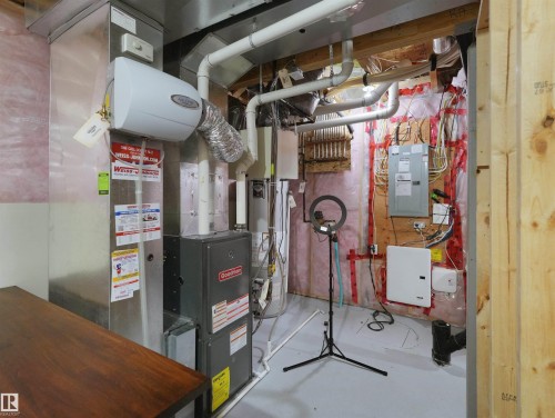 Utility room featuring a Goodman furnace, humidifier, and exposed ductwork - 7827 22 Avenue, Edmonton, AB 
