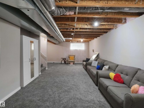 Expansive lower level featuring gray carpeting throughout and painted drywall - 7827 22 Avenue, Edmonton, AB 