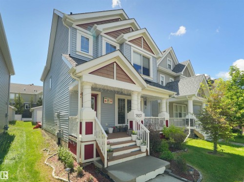 Multi-level residence featuring light blue siding with contrasting trim - 7827 22 Avenue, Edmonton, AB 